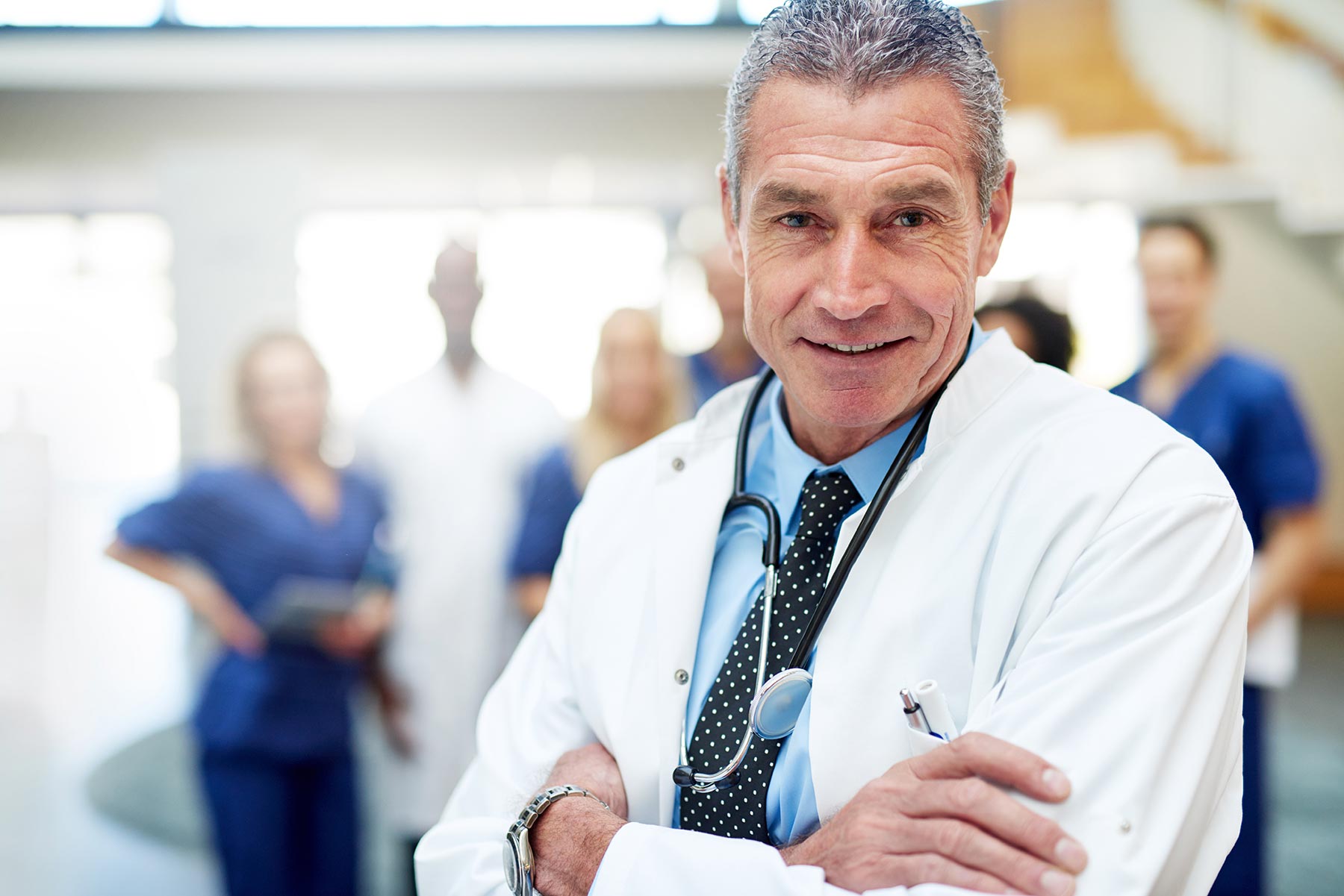 portrait-of-smiling-doctor-standing-with-arms-cros-A843CNX